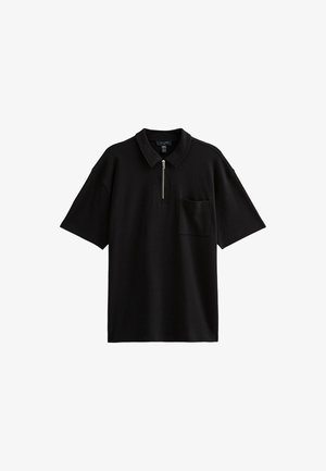 Black polo shirt made of cotton blend, featuring a half-zip front, short sleeves, and a left chest pocket. Smooth texture, relaxed fit.