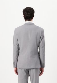 Gray tailored suit jacket with a smooth texture, single vent, and notch lapels. Features buttoned cuffs and a sleek, structured design.