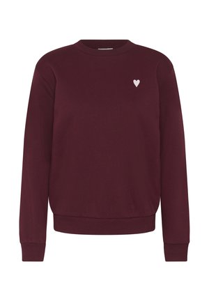 Sweatshirt bordeaux à col ras du cou en tissu doux, avec un emblème de cœur blanc sur le côté gauche de la poitrine et des poignets et un ourlet côtelés.