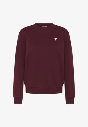 Sweatshirt bordeaux à col ras du cou en tissu doux, avec un emblème de cœur blanc sur le côté gauche de la poitrine et des poignets et un ourlet côtelés.