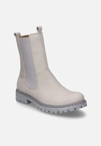 Crèmefarbene Knöchelstiefel mit elastischen Seiteneinsätzen, strukturiertem Leder, ziehbaren Schlaufen und einer robusten grauen Gummisohle.