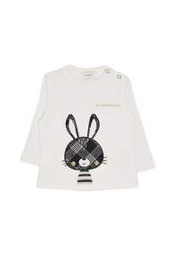 Camicia bianca a maniche lunghe con un design di coniglio a quadri bianco e nero, caratterizzata da accenti gialli e bottoni a pressione sulla spalla.