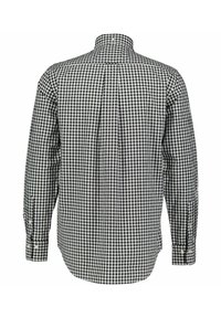 Long-sleeve shirt with a black and white checkered pattern, button-down collar, and buttoned cuffs. Cotton fabric with a classic fit.