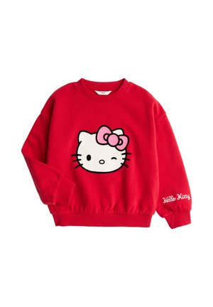 Felpa rossa a maniche lunghe con il viso di Hello Kitty che fa l'occhiolino e fiocco rosa sul davanti, e testo "Hello Kitty" ricamato sul polsino della manica.