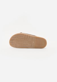 Sole of a brown shoe with textured grip and repeated "Copenhagen shoes" branding, size 37 visible near the heel.