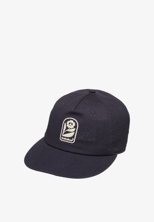 Ciemnoniebieska czapka bejsbolowa z płaskim daszkiem i białą łatką przedstawiającą kwiat oraz logo Quiksilver na przednim panelu.