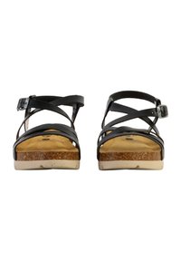 Sandalias negras con correas, con plantilla de corcho, diseño de correas cruzadas y hebilla ajustable en el tobillo. La suela de goma proporciona agarre y estabilidad.