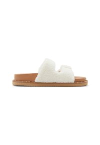 Cremefarvede slip-on sandaler med en fluffy tekstur, der har to remme og en lysebrun gummisål med dekorative nitter langs kanten.