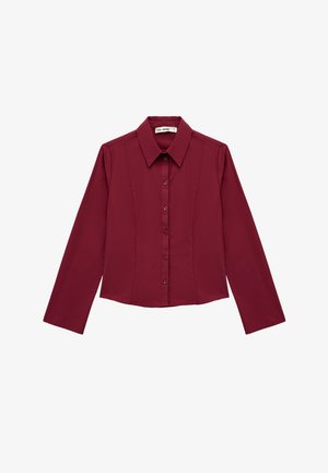 Burgunderfarbenes Langarmhemd mit spitzem Kragen, frontaler Knopfleiste und taillierter Passform, mit vertikalen Abnähern zur Formgebung.
