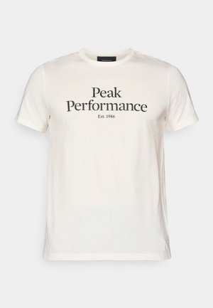 T-shirt in cotone color crema con la scritta "Peak Performance" e "Est. 1986" stampate in nero, con maniche corte e scollatura a girocollo.