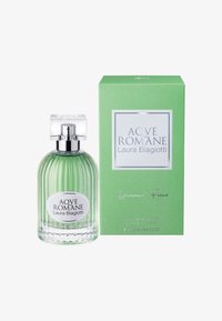 Klare Glasflasche mit vertikalen Rippungen, grüne Flüssigkeit, silberner Verschluss; begleitet von einer grünen Box mit weißem Etikett und silbernem Text.