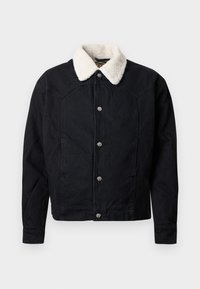 Chaqueta de mezclilla negra con un cuello de piel sintética de color crema, cierre de botones a presión y mangas largas. Presenta costuras visibles y bolsillos.