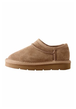 Brown suede slip-on shoe with thick rubber sole and visible stitching, designed for casual wear.