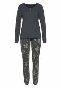 Gray long-sleeve top with three-button placket paired with dark patterned pants featuring floral designs in various colors.