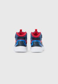 Pair of navy blue, red, and white athletic shoes viewed from the back with cushioned white soles and fabric pull tabs on a white background.