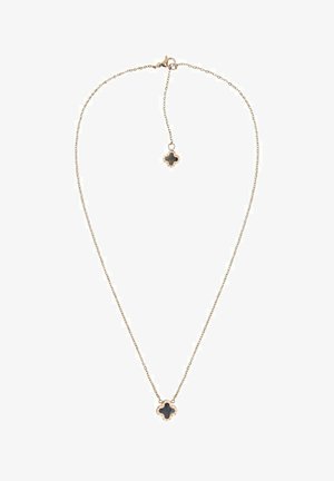 Delicate gouden ketting met zwart klavervormig hangertje en bijpassende kleine klavervormige bedel bij de sluiting op een witte achtergrond.