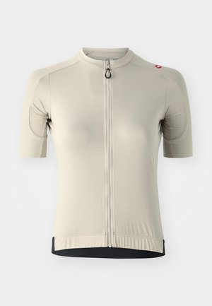 Maillot de cyclisme à manches courtes en beige clair, avec une fermeture éclair avant intégrale, texture côtelée et ourlet noir contrastant. Comprend un accent de logo.