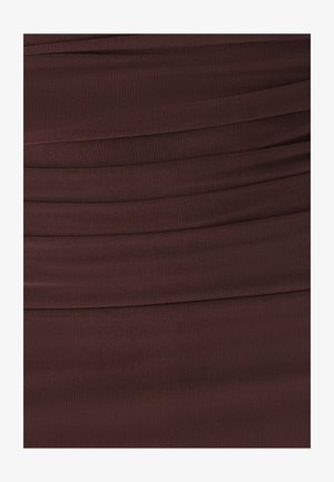 Brūna teksturēta auduma ar horizontāliem krokām, kurš izceļas ar acu līdzīgu rakstu. Virsma šķiet nedaudz stiepjama un struktūrēta.