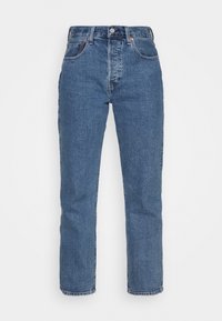 Jeans de mezclilla azul de pierna recta con un diseño clásico de cinco bolsillos, un ligero desgaste y costuras visibles. Cuenta con un botón metálico y una cremallera.