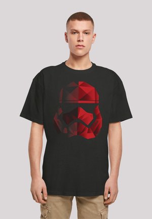 Black short-sleeve t-shirt featuring a geometric, red Stormtrooper helmet graphic. The design includes angular shapes and varied shading.