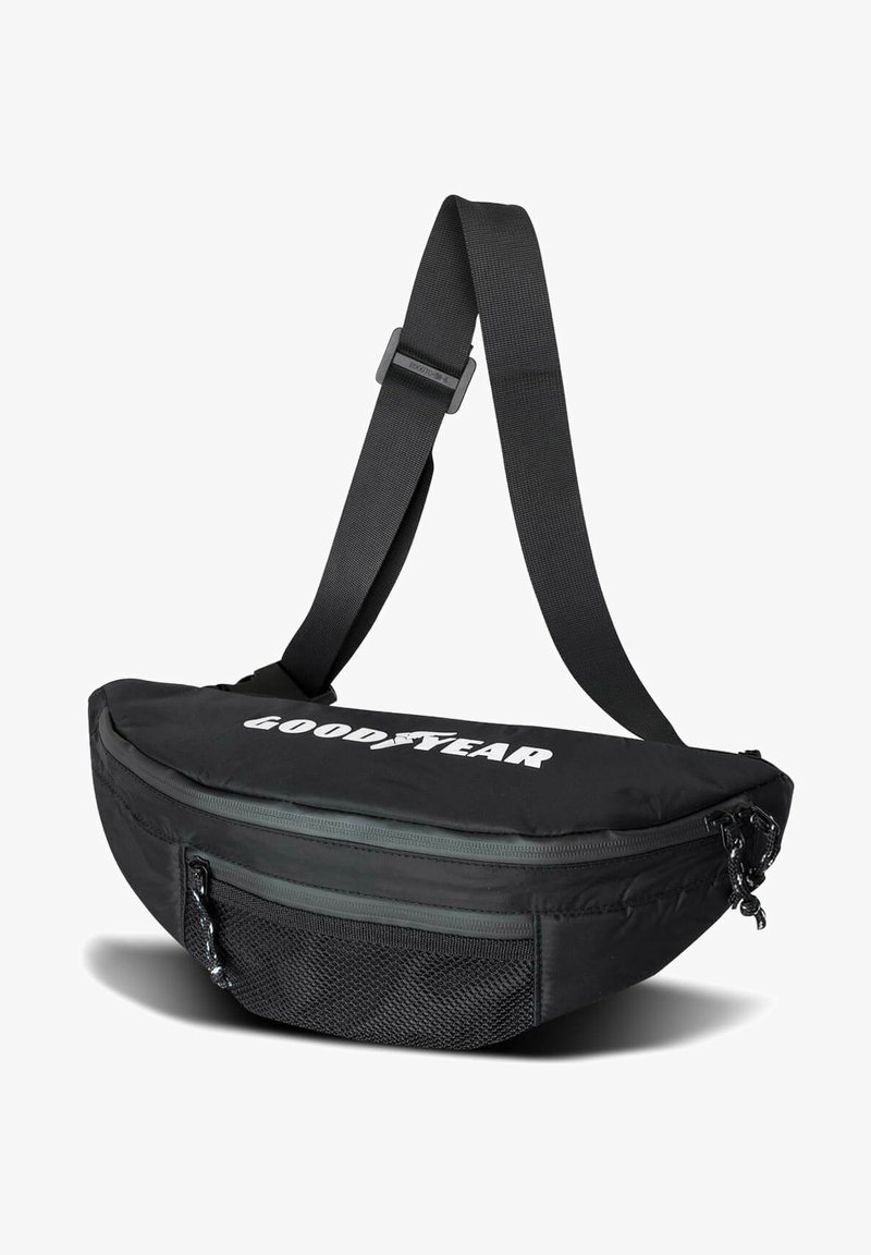 Black fabric sling bag with a curved shape, zippered compartments, mesh pocket, and adjustable strap; features a white "GOODYEAR" logo.