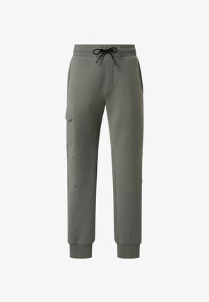 Grønne sweatpants med elastisk talje, justerbar snor, sidelommer, ribbede cuffs og diskrete syninger på siderne.