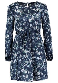 Robe florale en tissu bleu marine avec des manches longues, une taille cintrée et un col rond avec un détail en trou de serrure. Motif floral en couleurs claires.