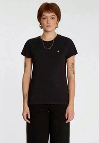 Black cotton t-shirt with short sleeves, a round neckline, and a small logo on the left chest area. Smooth texture and classic fit.