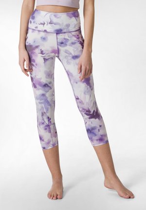 Leggings realizzati in un tessuto elasticizzato con un motivo floreale in acquerello nei toni del viola, dotati di una vita alta e di una lunghezza cropped.