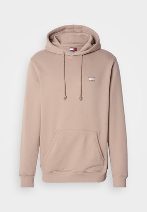 Beige kapucnis pulóver elülső zsebbel, állítható húzózsinórral és egy kis logóval a mellkason. Puha anyag, ribbelt mandzsettával és szegéllyel.