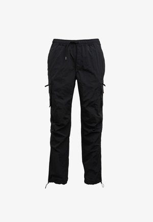 Sorte cargo bukser lavet af letvægtsmateriale, med elastisk talje, sidelommer med lynlås og justerbare ankelmanchetter.