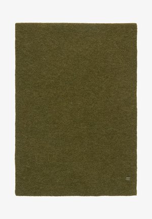 Tapis rectangulaire en laine de couleur olive unie avec une petite étiquette de marque grise dans le coin inférieur droit.
