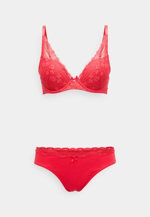 Red lace-trimmed bra and matching brief set. Bra features padded cups and adjustable straps; brief has a lace waistband and soft fabric.