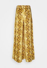 Gula och bruna byxor med ormiga mönster i vida ben och hög midja. Tyget har ett strukturerat mönster och en slät yta.