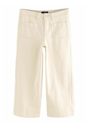Crème kleurige cropped broek, gemaakt van denim, met twee achterzakken, gestikte naden en een omgeslagen zoom. Knoop- en ritsluiting.