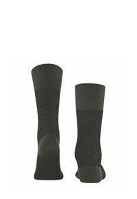 Calze verdi scuro con bordo a coste e motivo a zigzag sul corpo. Presentano talloni e punte rinforzati per una maggiore durata.