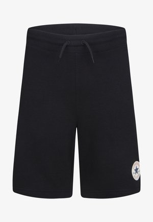 Shorts en coton noir avec une taille élastique et un cordon de serrage, ornés d'un patch logo circulaire sur la partie inférieure de la jambe gauche.