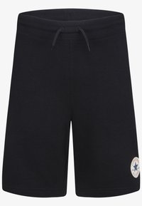 Shorts en coton noirs avec une taille élastique et un cordon de serrage réglable ; présente une patch logo sur la jambe gauche. Texture lisse.