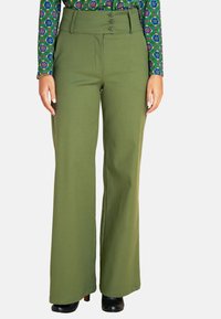 Olive green wide-leg pants with a high waist, featuring three buttons and a smooth texture. Worn with black heels.