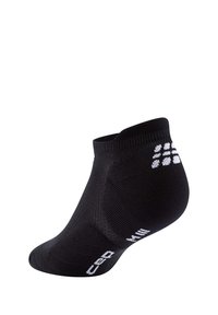 Calzini neri alla caviglia realizzati in materiale lavorato a maglia, con bordo a costine, logo bianco sul lato e design della punta senza cuciture.