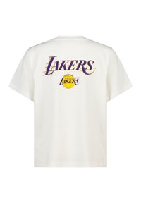 White cotton t-shirt featuring a large purple and yellow "LAKERS" graphic on the back, with a basketball icon and stylized font.