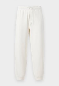 Pantalon de survêtement blanc avec une taille élastique et un cordon de serrage ajustable. Poignets aux chevilles ; texture douce et lisse, convenant pour une tenue décontractée.