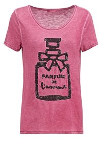 Růžové bavlněné tričko s kulatým výstřihem a krátkými rukávy, na kterém je černý flitrový grafický motiv parfému a text pod ním.