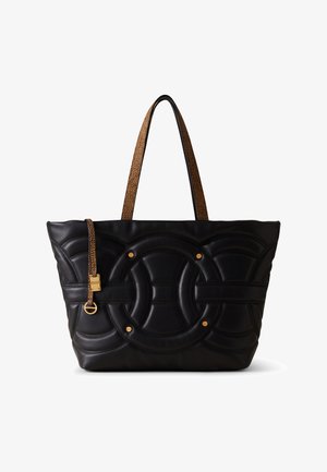 Black leather tote bag with quilted circular design, gold hardware accents, and contrasting textured brown handles.