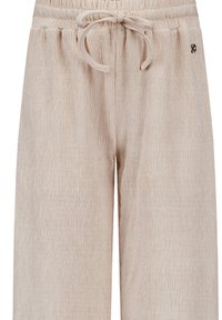 Světle béžové široké kalhoty vyrobené z texturované tkaniny. Obsahují elastický pas se šňůrkou a malým logem.