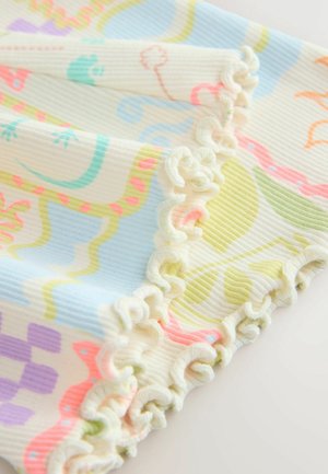 Pealtvaade pehmest soonikust kangast, millel on värvikad abstraktsed dinosauruse mustrid ja valge salatilehest ääris heledal taustal.