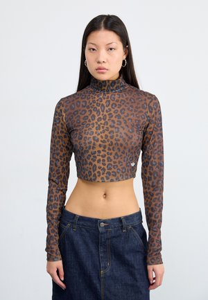 Leopard print long-sleeve crop top in a sheer brown fabric with a mock neck design and logo detail at the hem, paired with a dark denim skirt.