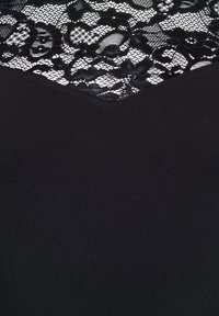 Črna tkanina z cvetnim čipkastim panelom, ki ima prozorno mrežno ozadje ter zapletene vzorce cvetov in listov.