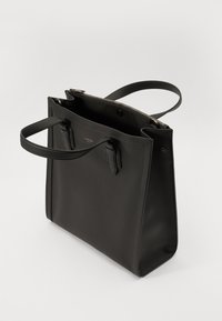 Black leather tote bag with a structured shape, double handles, and a zip closure. The interior is lined and features minimal hardware accents.