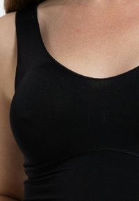 Black tank top with a smooth, stretchy texture, featuring wide straps and a rounded neckline. Simple design with no visible patterns or hardware.